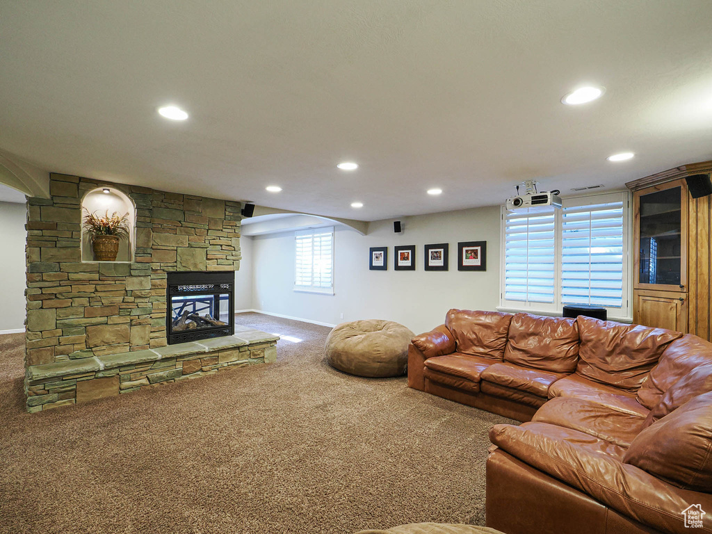 Carpeted living room featuring recessed lighting, a fireplace, and baseboards