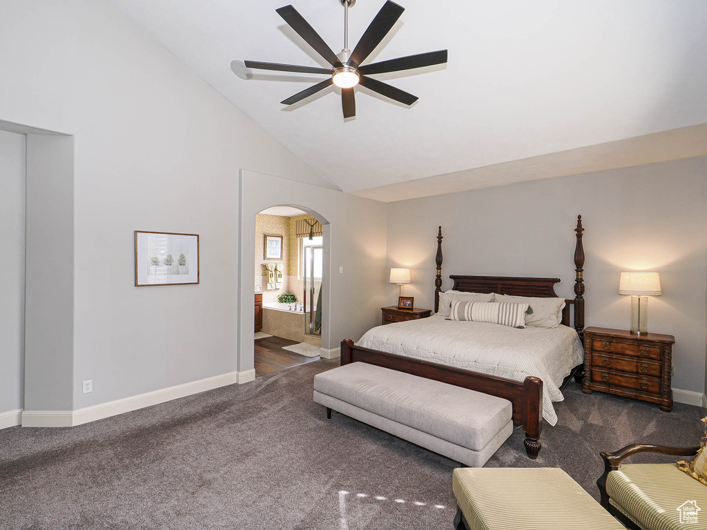 Carpeted bedroom featuring arched walkways, baseboards, ensuite bath, a ceiling fan, and high vaulted ceiling