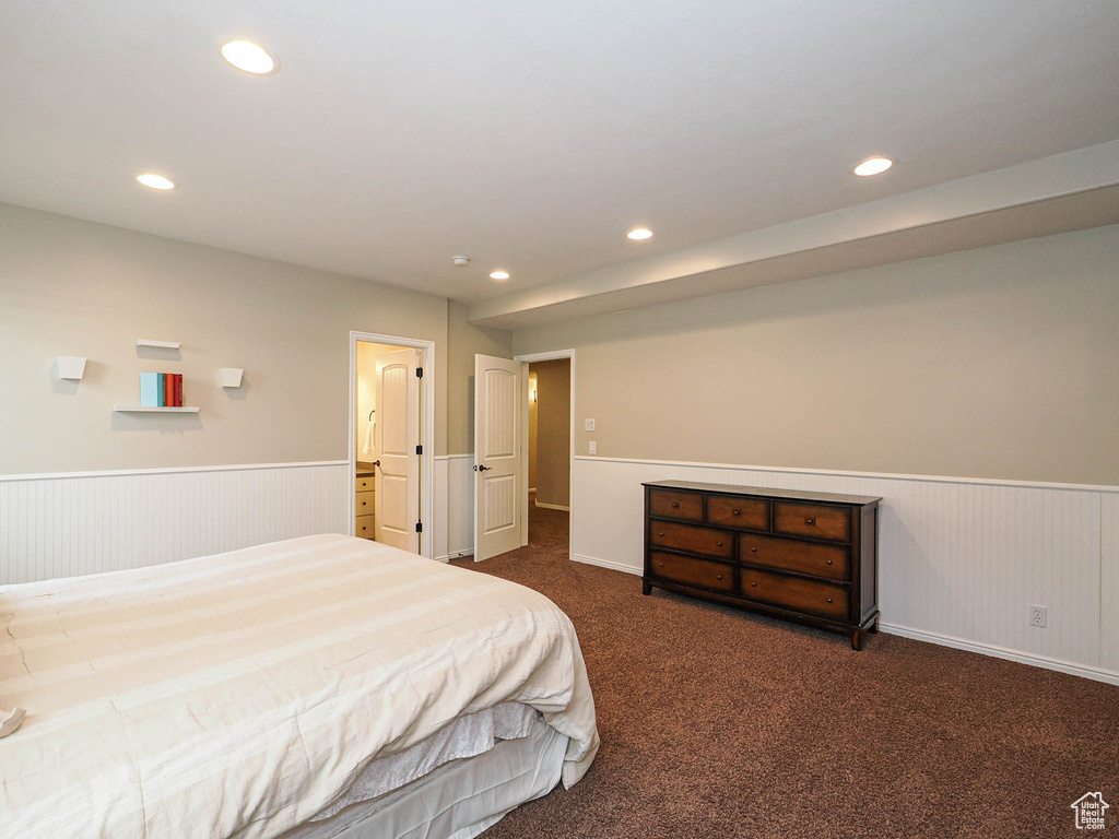 Carpeted bedroom with wainscoting and recessed lighting