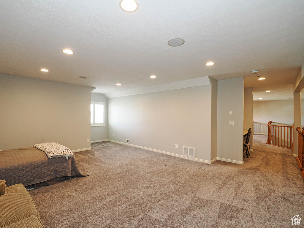 Below grade area with light carpet, recessed lighting, and baseboards
