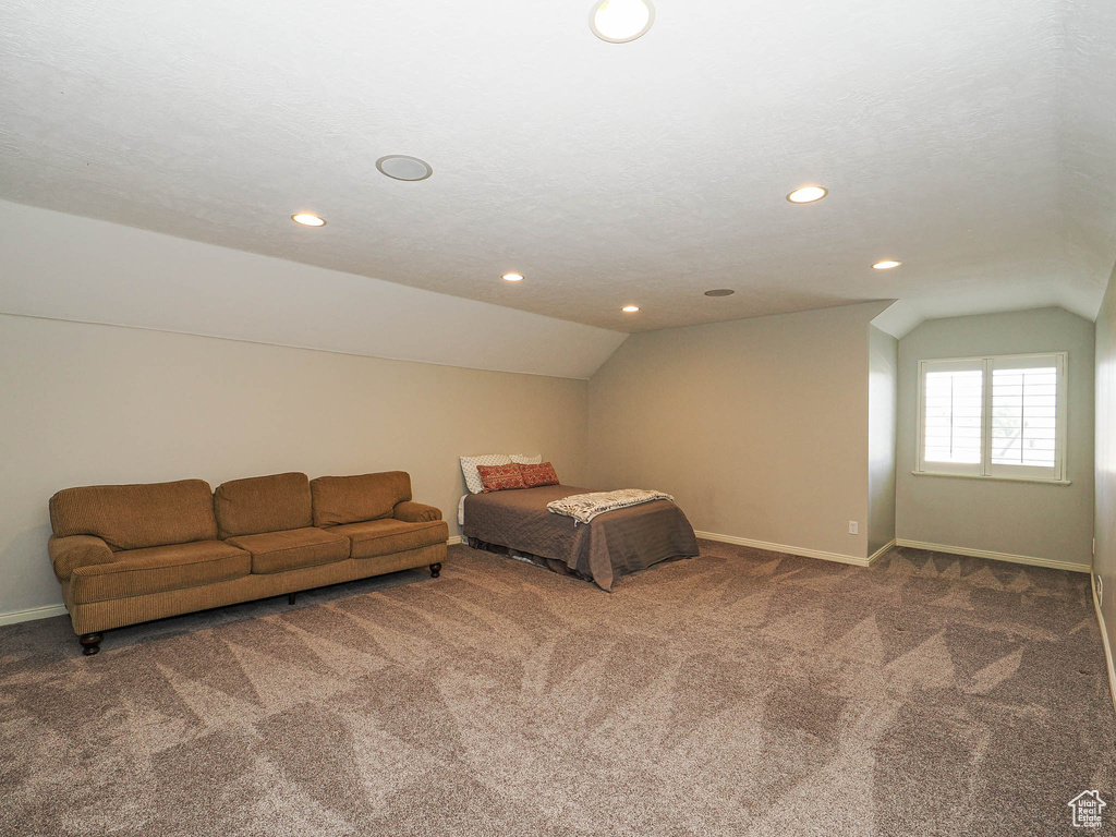 Bedroom featuring lofted ceiling, carpet floors, recessed lighting, and baseboards