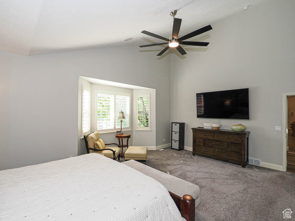 Carpeted bedroom with baseboards, high vaulted ceiling, and a ceiling fan