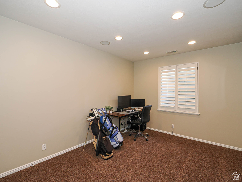 Carpeted office space featuring recessed lighting and baseboards