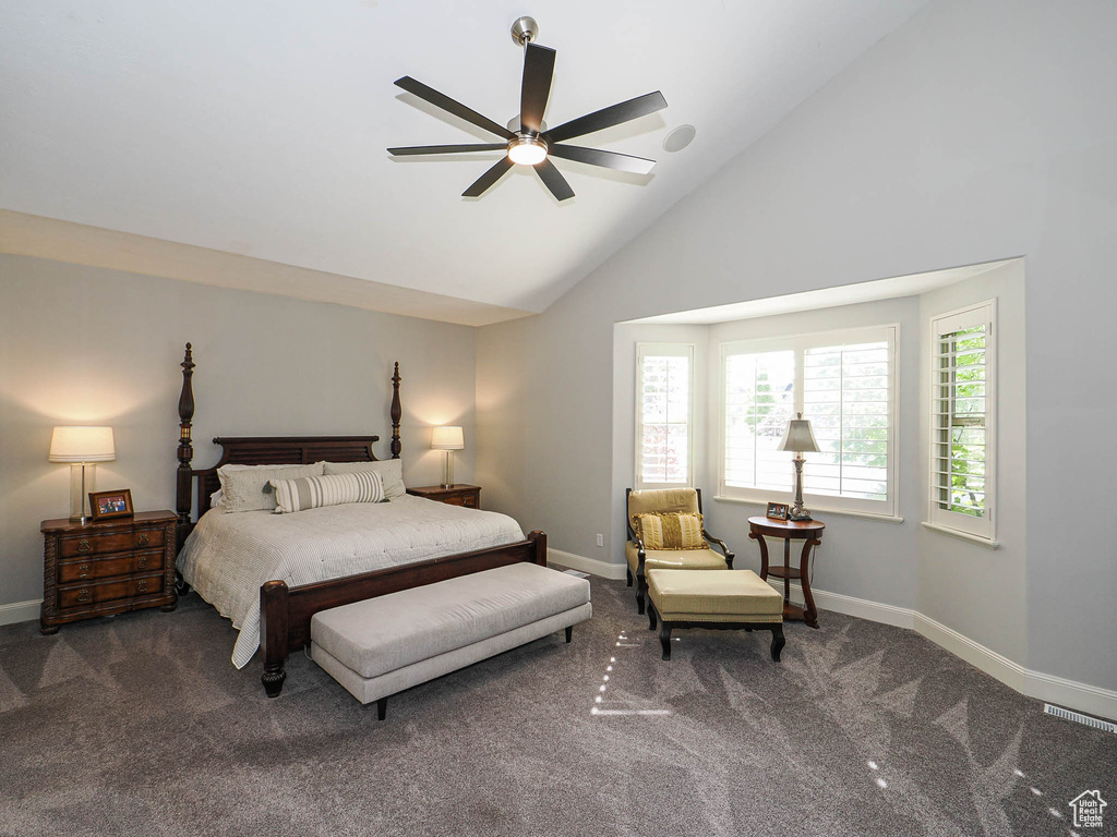 Carpeted bedroom featuring baseboards, high vaulted ceiling, and ceiling fan