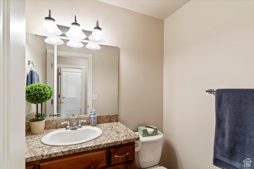 Half bath with vanity and toilet