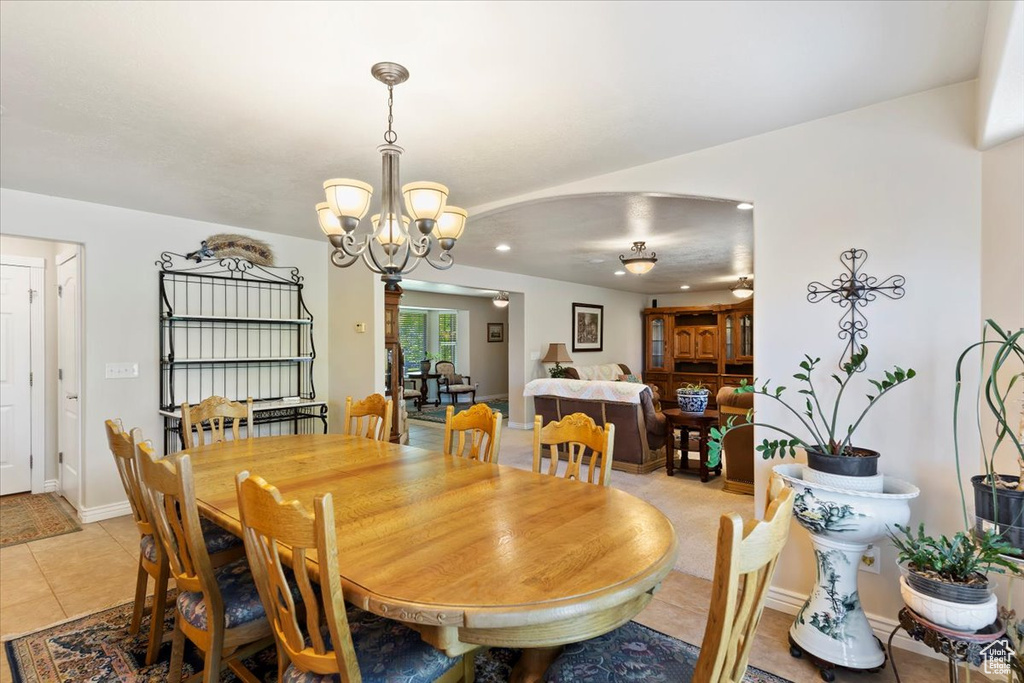 Dining room featuring a chandelier, light tile patterned floors, recessed lighting, and baseboards