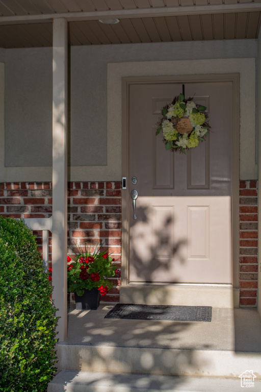 Property entrance featuring brick siding