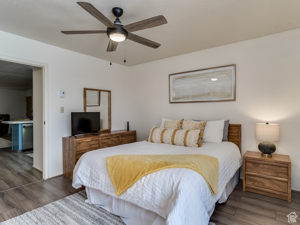 Bedroom featuring wood finished floors, baseboards, and a ceiling fan