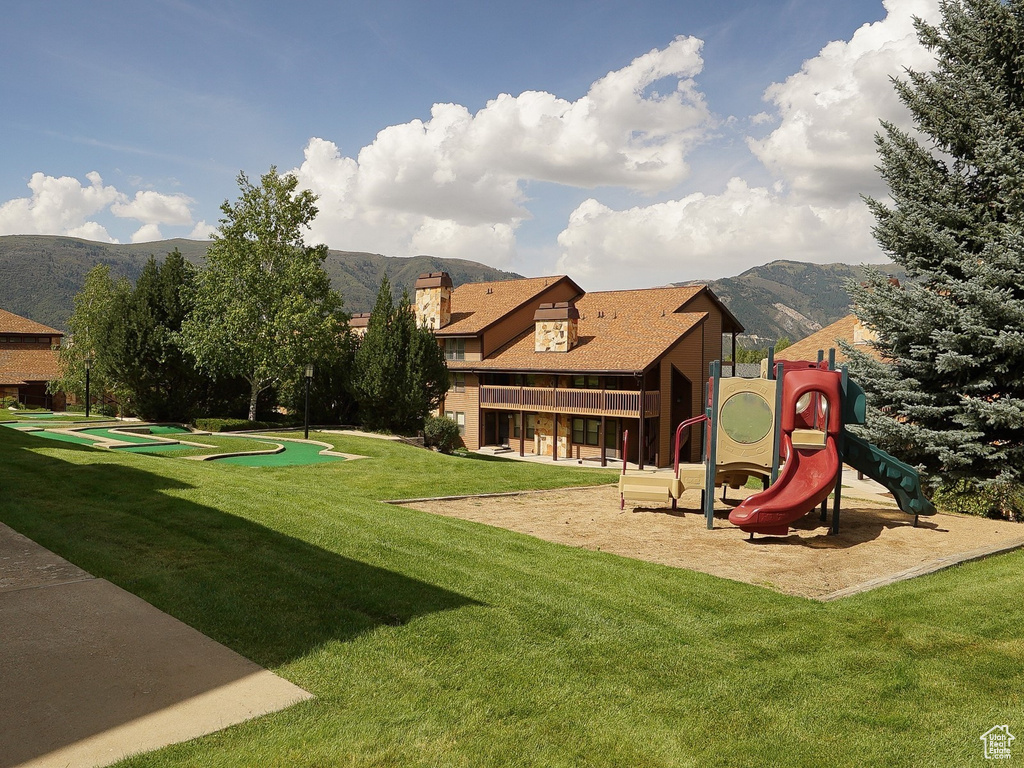 View of grassy yard with a mountain view