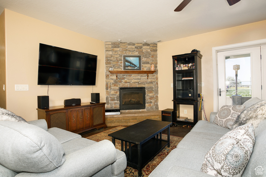 Living area featuring a ceiling fan and a fireplace