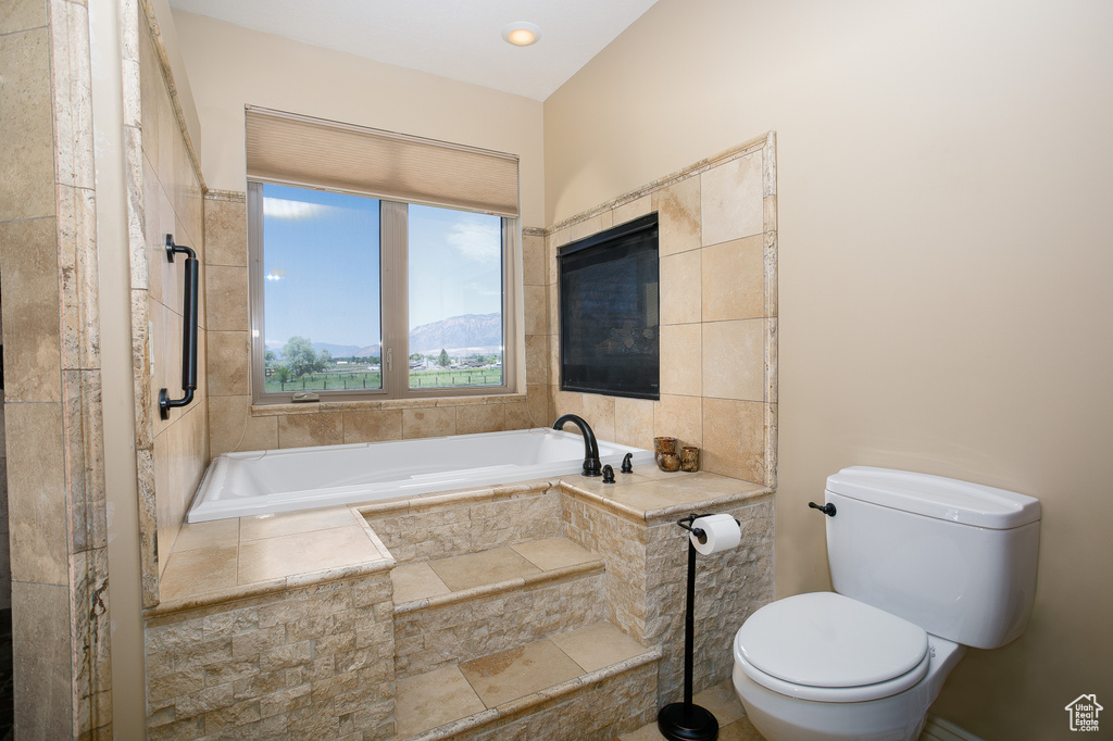 Full bathroom with a bath and toilet