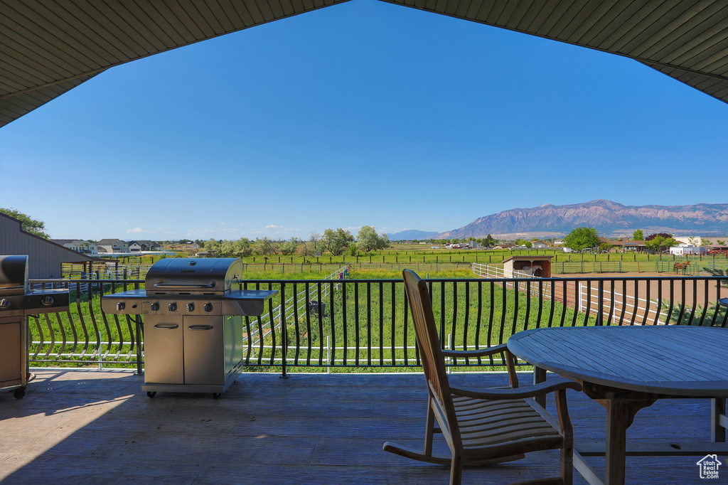 View of patio with a mountain view and area for grilling