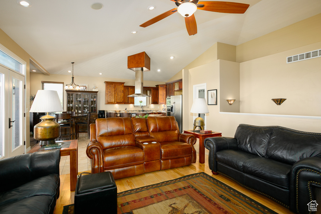 Living room with ceiling fan, vaulted ceiling, recessed lighting, and light wood-type flooring