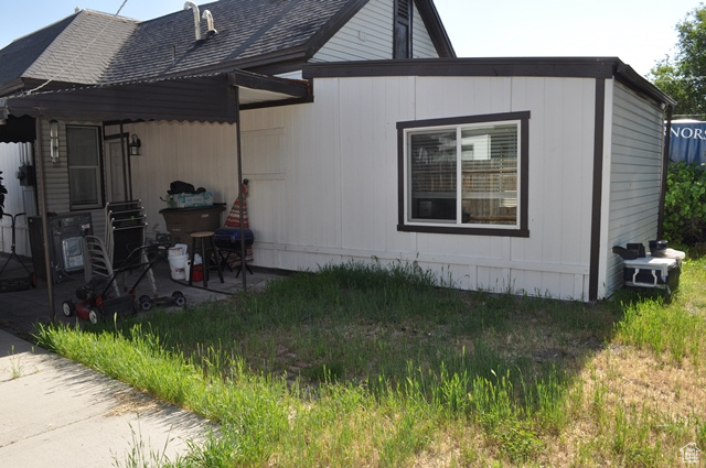 View of property exterior with roof with shingles