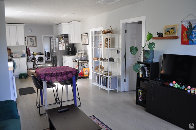 Living area with light wood-style floors