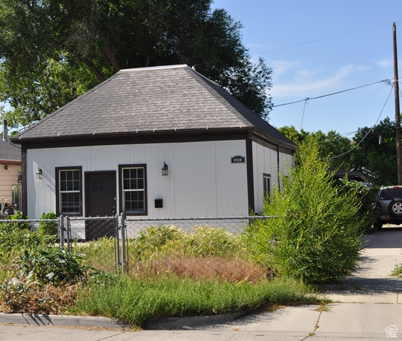 View of side of property featuring a shingled roof