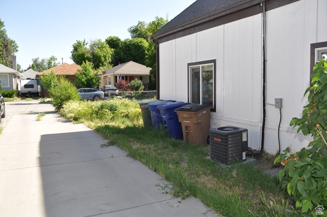 View of side of home with central AC unit