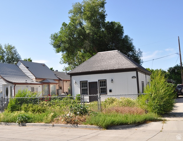 View of front of home with roof with shingles