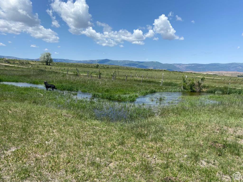View of mountain background with rural landscape and a nearby body of water
