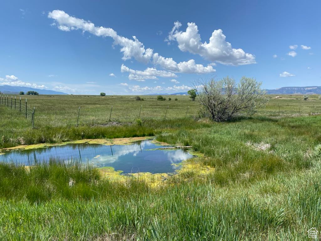 Water view with rural landscape and a mountainous background