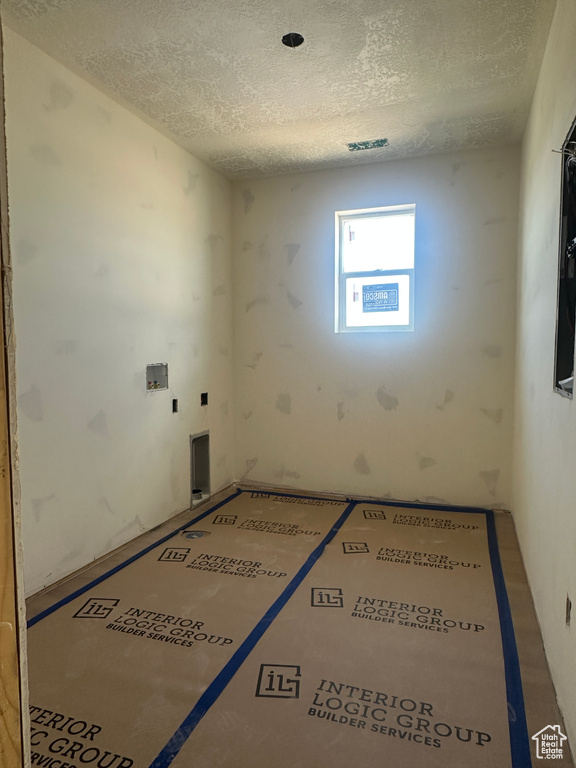 Empty room with a textured ceiling