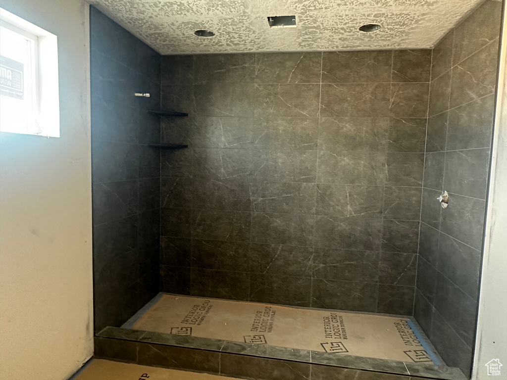 Bathroom featuring tiled shower