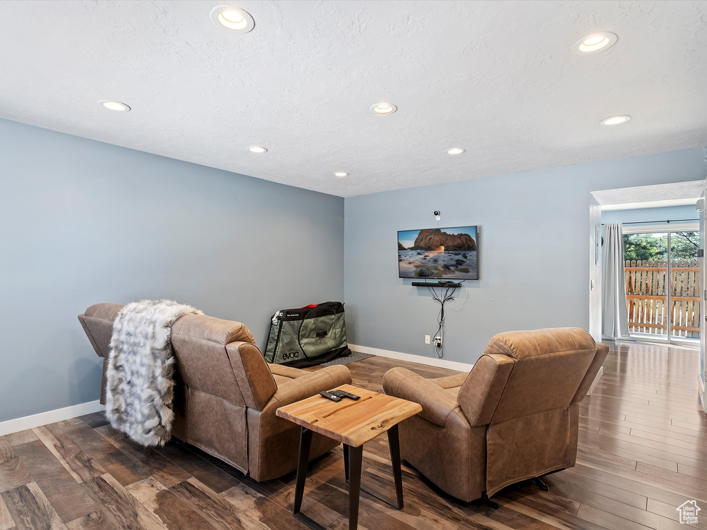 Living area with recessed lighting, baseboards, and dark wood-style flooring