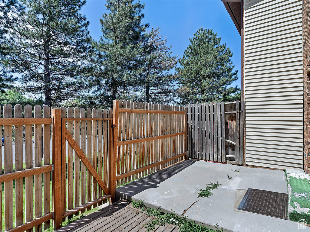 Wooden terrace with a gate and a patio