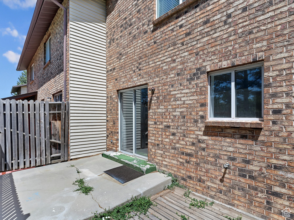 View of exterior entry featuring brick siding