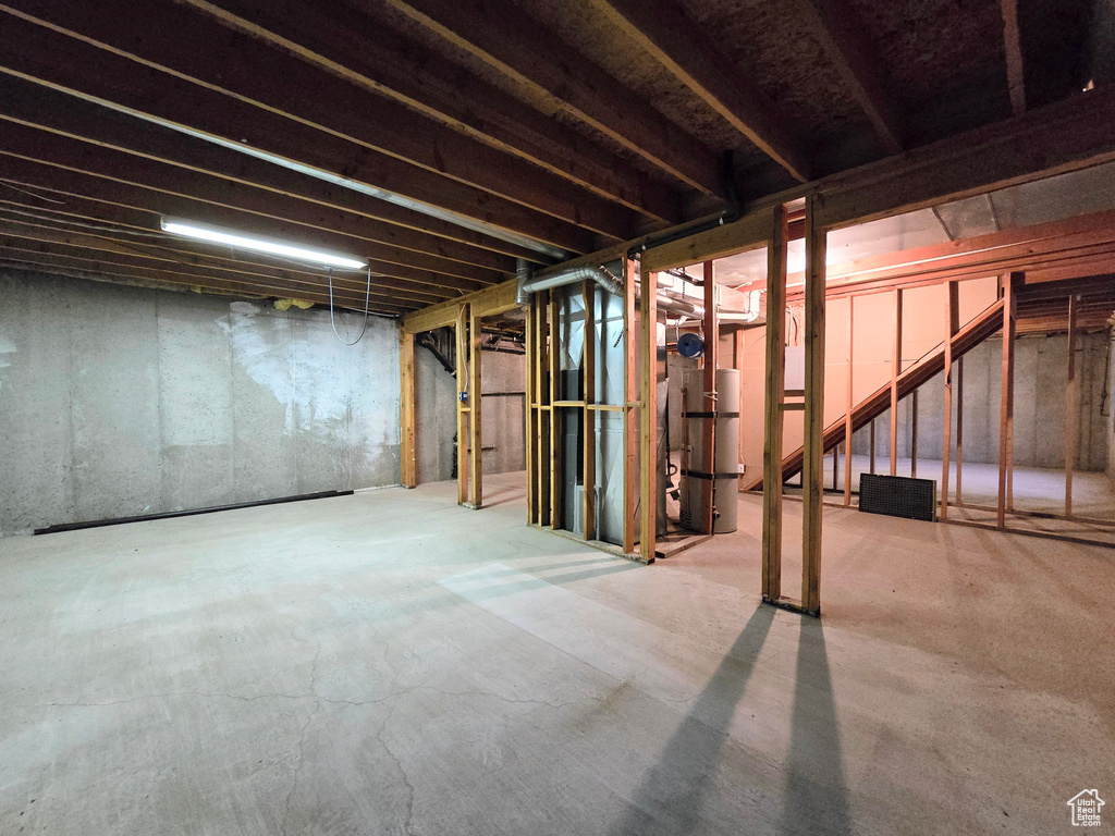 Unfinished basement with strapped water heater