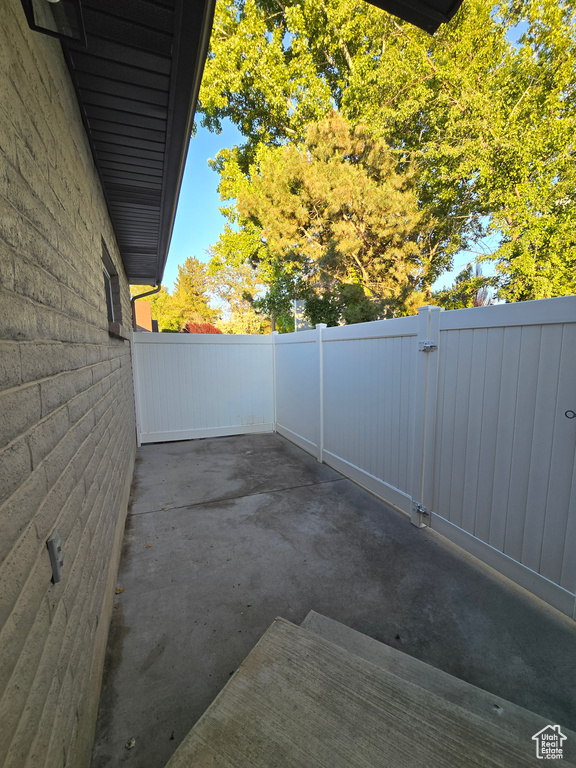 View of patio with a gate