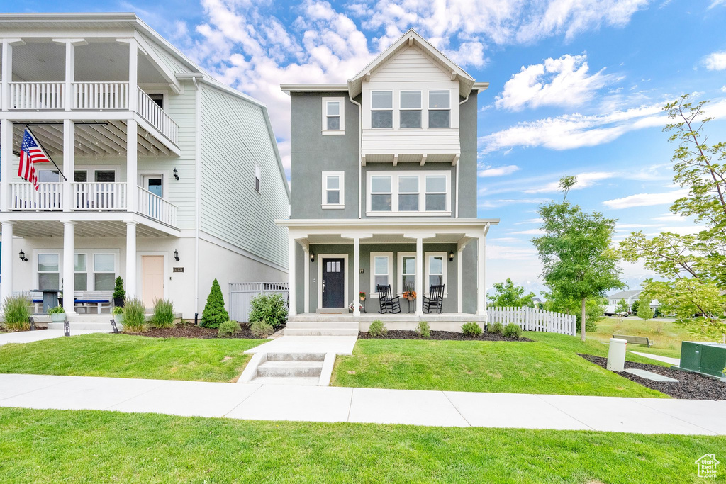 View of front of property with stucco siding and covered porch