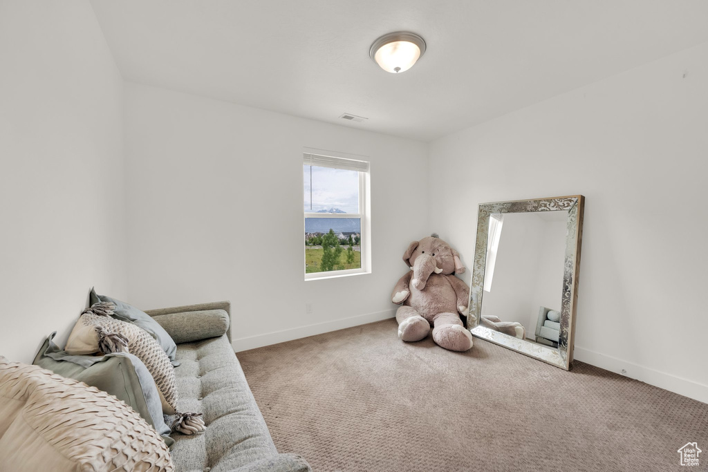Living area with carpet flooring and baseboards