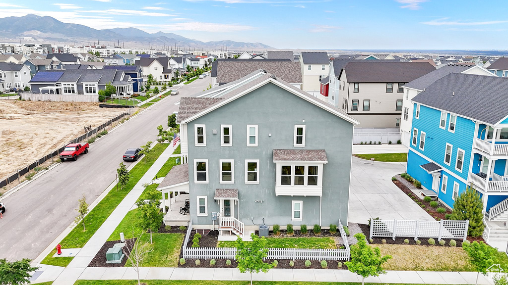 View of front of home featuring stucco siding, a residential view, and a mountain view