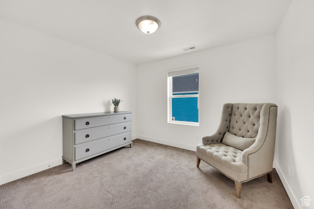 Living area with carpet flooring and baseboards