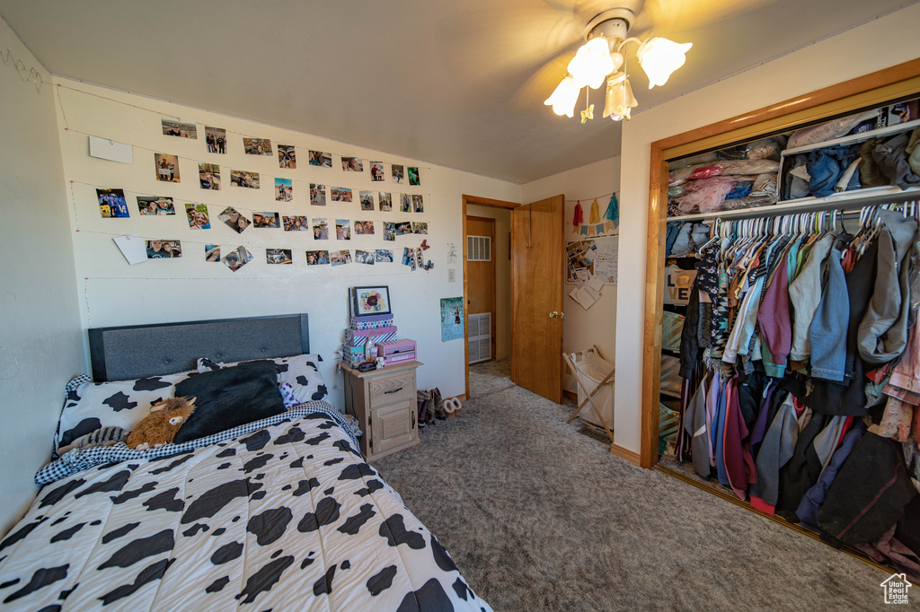 Carpeted bedroom with a closet