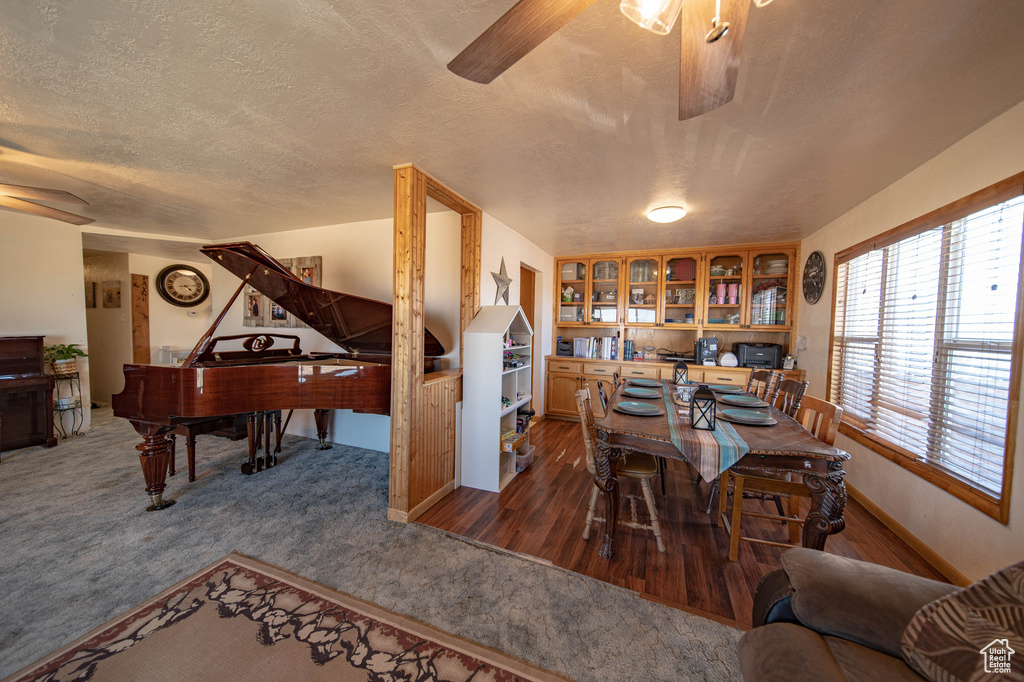 Dining room featuring ceiling fan and a textured ceiling