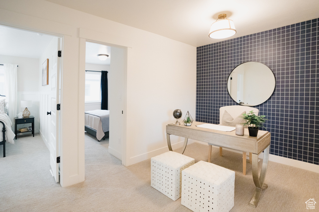 Office space with light colored carpet and tile walls
