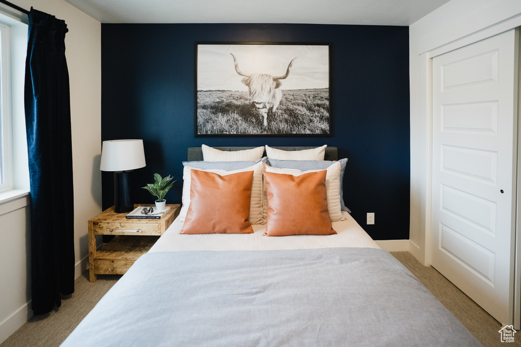 Bedroom featuring carpet flooring and baseboards