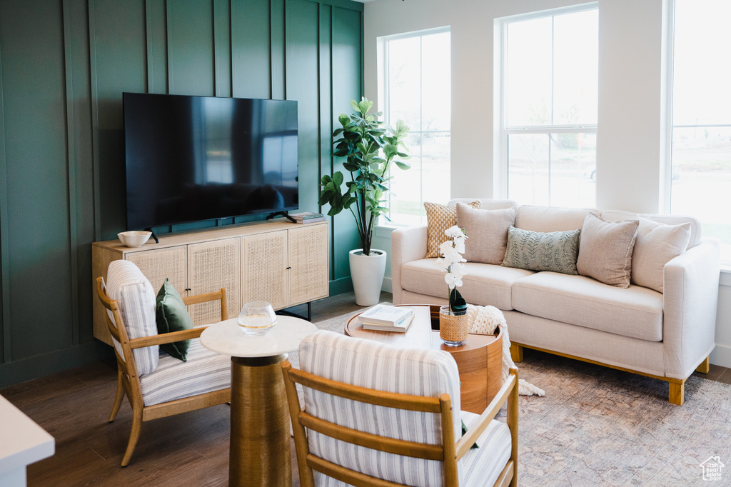 Living room with wood finished floors and healthy amount of natural light