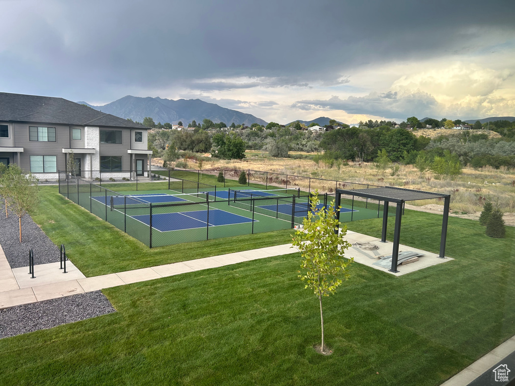 View of tennis court with a mountain view