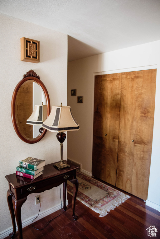 Foyer entrance featuring wood finished floors and baseboards