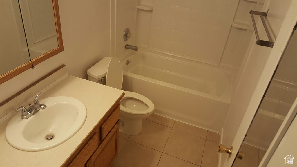 Bathroom featuring toilet, tile patterned flooring, vanity, and shower / tub combination