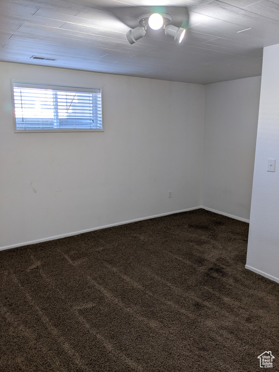 Carpeted empty room with baseboards