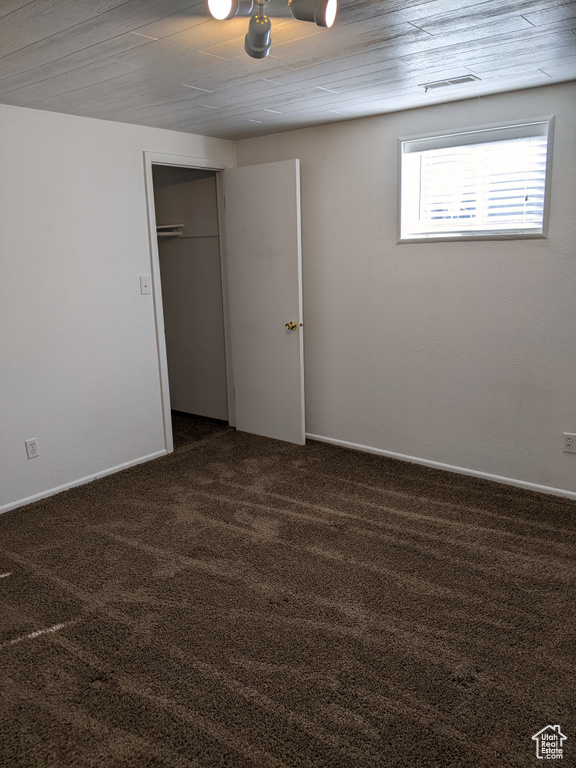 Unfurnished bedroom with carpet, a closet, and baseboards