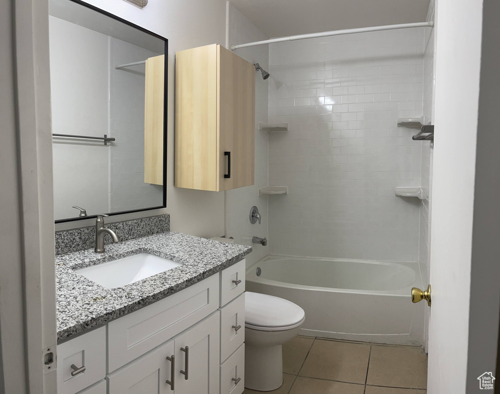 Full bathroom featuring vanity, tile patterned flooring, toilet, and bathtub / shower combination