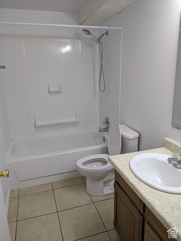 Bathroom featuring toilet, vanity, shower / washtub combination, and tile patterned floors