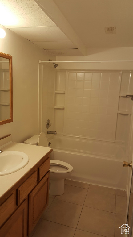 Full bath featuring vanity, tile patterned floors, toilet, and shower / bathtub combination