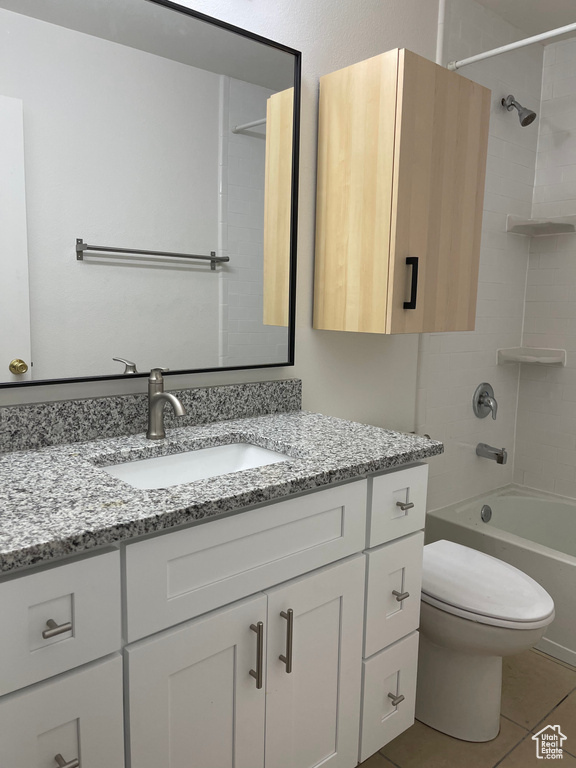 Full bathroom with vanity, shower / bath combination, toilet, and tile patterned flooring