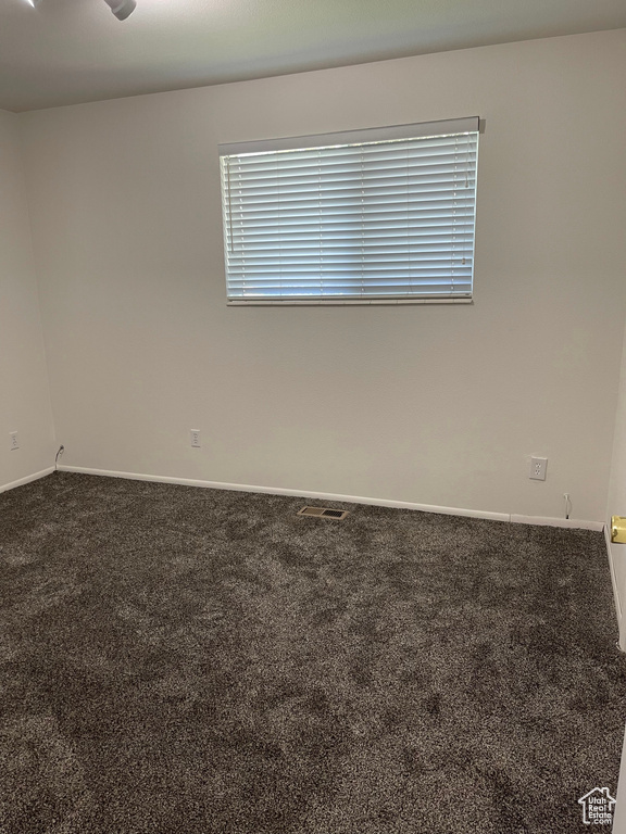 Carpeted spare room with baseboards